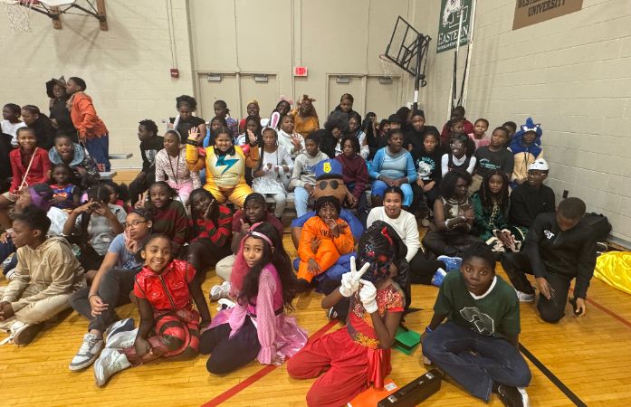  6th graders posing with different Halloween costumes on