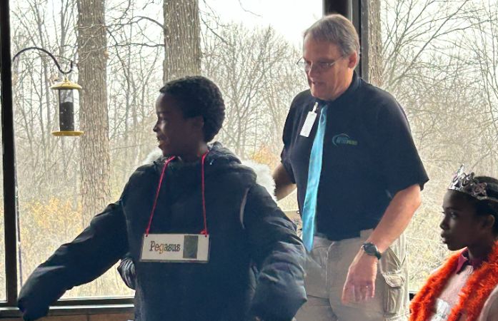  a nature center instructor and a 5th grade student participating in an activity