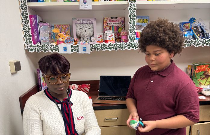  a student redeeming their points in the dojo store
