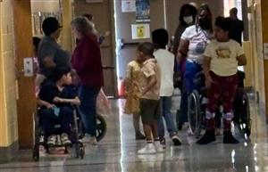 Students and staff walking in hallway
