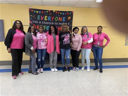 Keidan Staff dressed in pink standing in the hallway