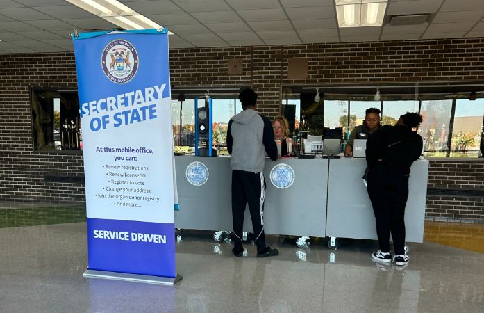 2 people at the SOS mobile counter talking to representatives