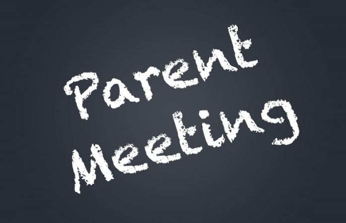  blackboard with chalk writing that says parent meeting