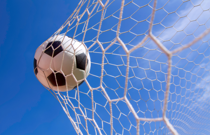  soccer in the goal hitting the net