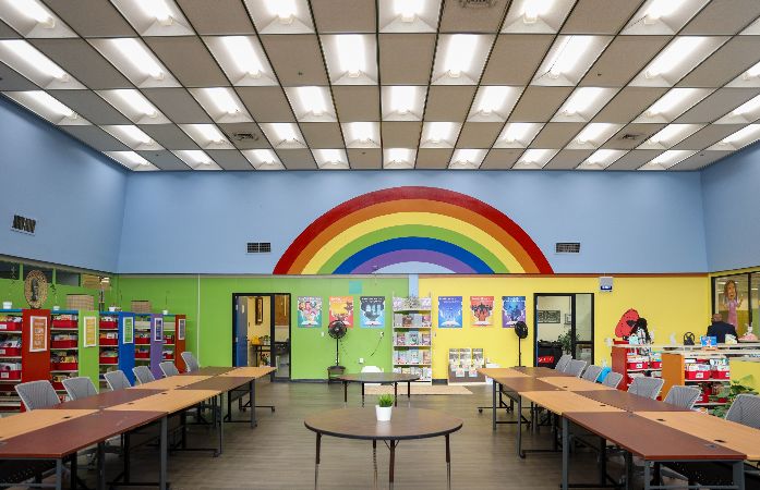 inside of new library with rainbow mural on the wall