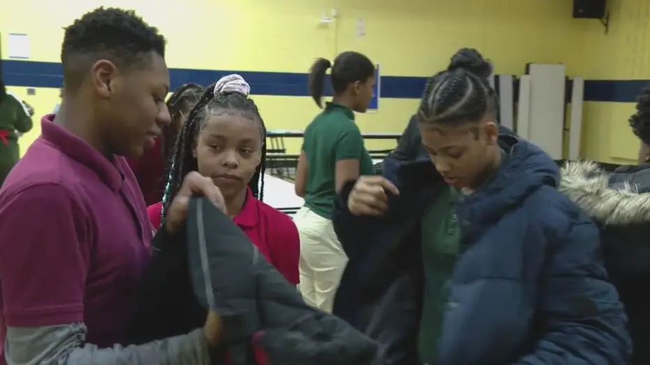  Students trying on coats 