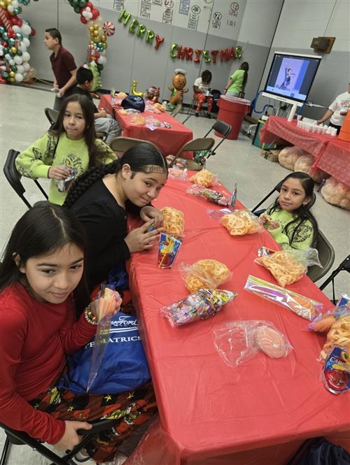 students sitting at a table eating snacks