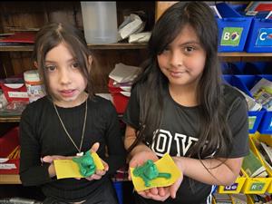  2 GIRLS HOLDING CLAY CREATIONS
