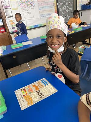 student smiling over 100th day snack