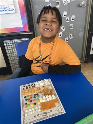 student smiling over 100th day snack