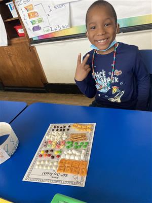 student smiling over 100th day snack