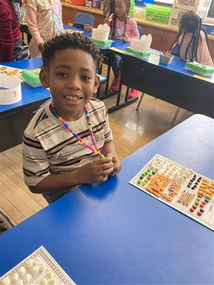 student smiling over 100th day snack