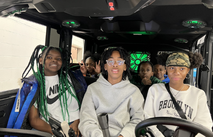  6 middle school student sitting in car at autorama 