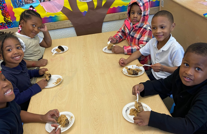  students smiling making bird feeders