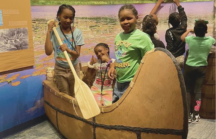  3 3rd grade students in a canoe 