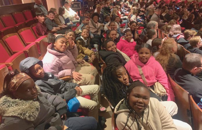  4th grade student sitting in chairs at the detroit orchestra hall 