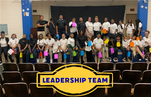 the leadership team posing on a stage