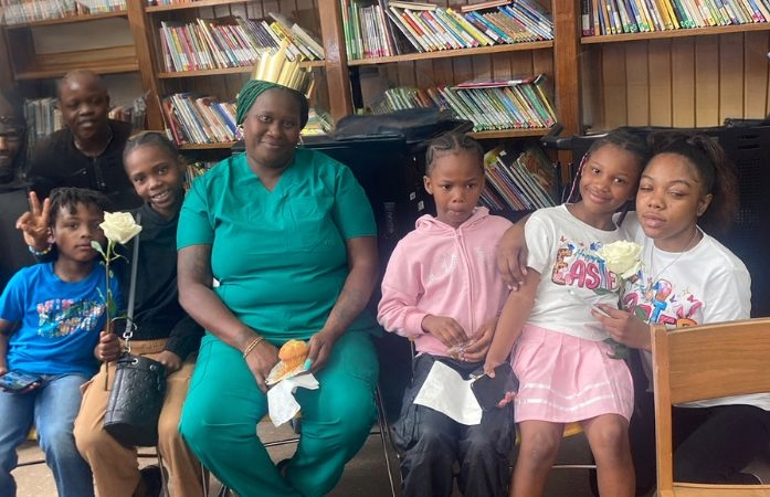  family smiling sitting in front of bookcases
