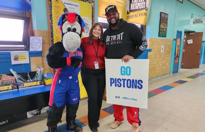 pistons mascot hooper with principal and another man