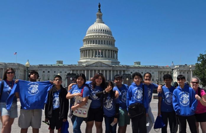  Students and coaches smiling in front of the capitol building in Washington DC