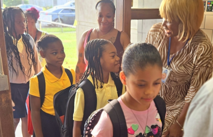 Principal greeting students