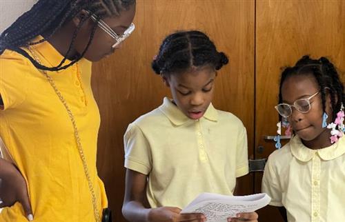 Group of girls presenting school-wide information
