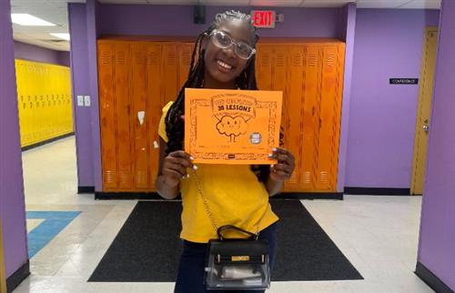 Student holding Zearn certificate.