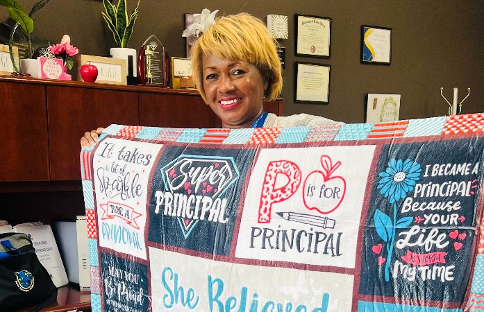  School principal holding her principal's blanket