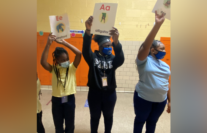  Foundational Skills sign held by students 