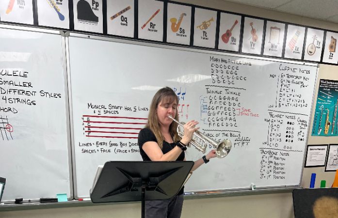  Band teacher modeling how to play a song