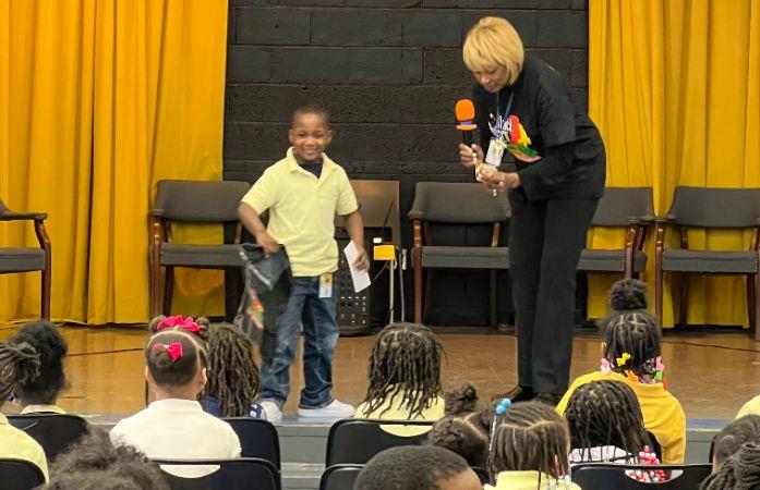  Boy standing on stage with principal
