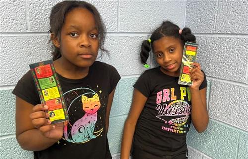2 girls holding up black history bookmark