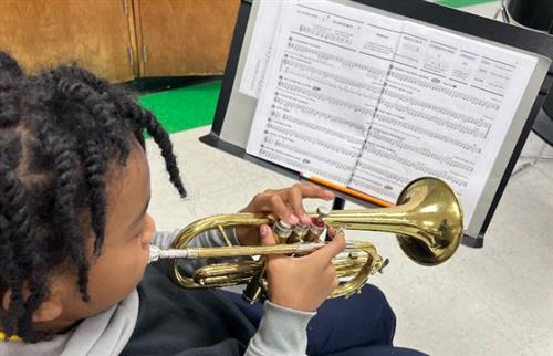 Student playing instrument during class.