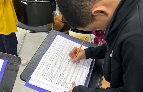 Middle school student studying music notes.