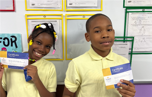  Barton students smiling with NAEP certificate.
