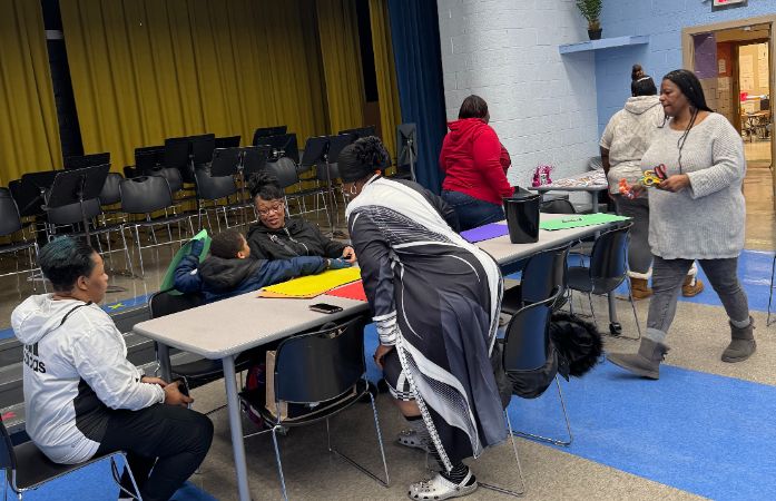  Families sitting at table to create