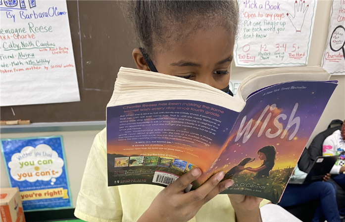   Student reading 'Wish" for Battle of the Books