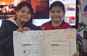 Two students holding poster