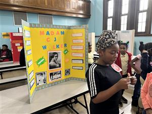 Student standing at Madam CJ Walker project
