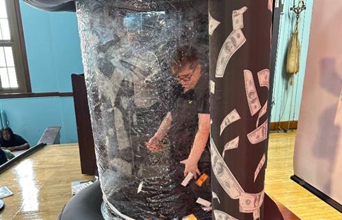 student in prize grab machine