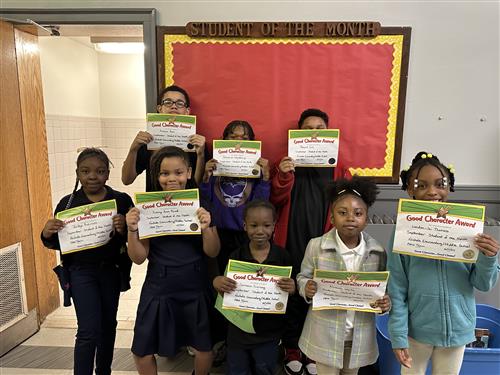 student of the month students posing with their certificates