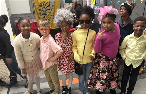  students posing in the hallway celebrating 100 days of school