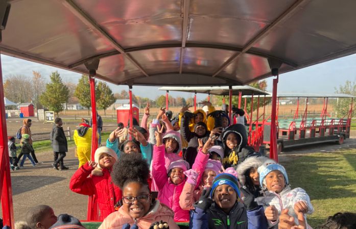  students on train at the apple orchard
