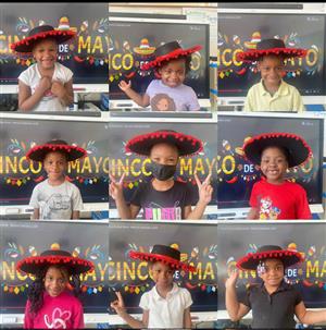 Students posing in Mexican sombrero hat 
