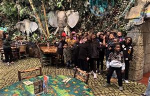  group of students standing in front of the elephant exhibit at Rainforest Cafe