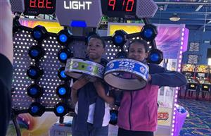  two students standing with game tickets