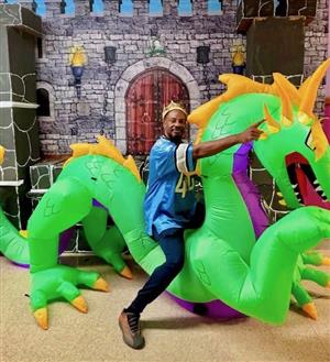 man sitting on a blow-up dragon