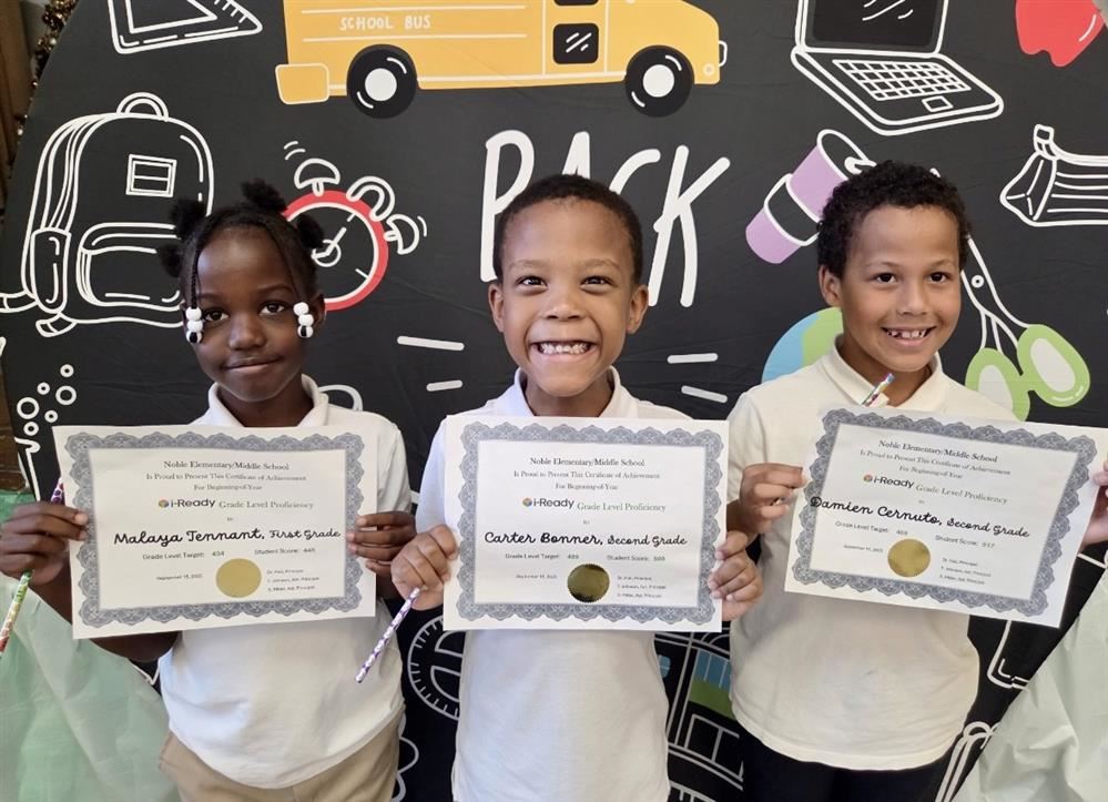  picture of students holding certificates