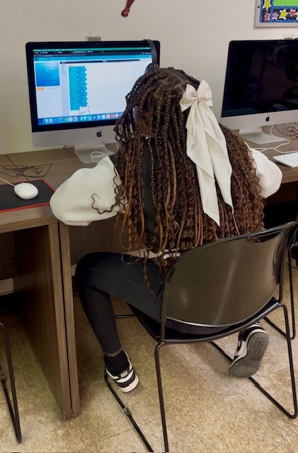  Girl sits at a computer