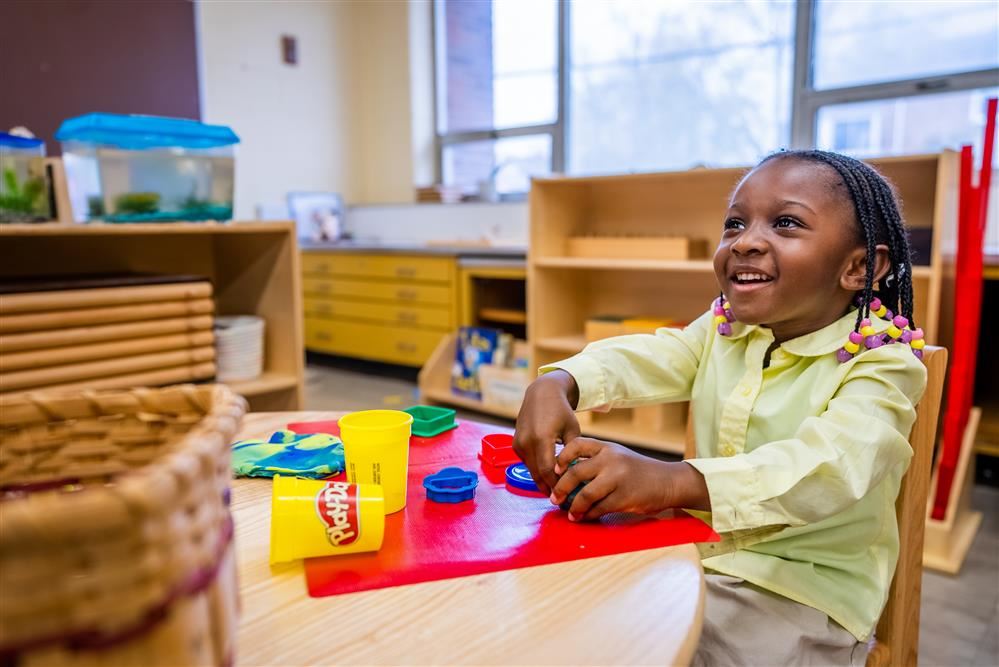  child playing with playdough 